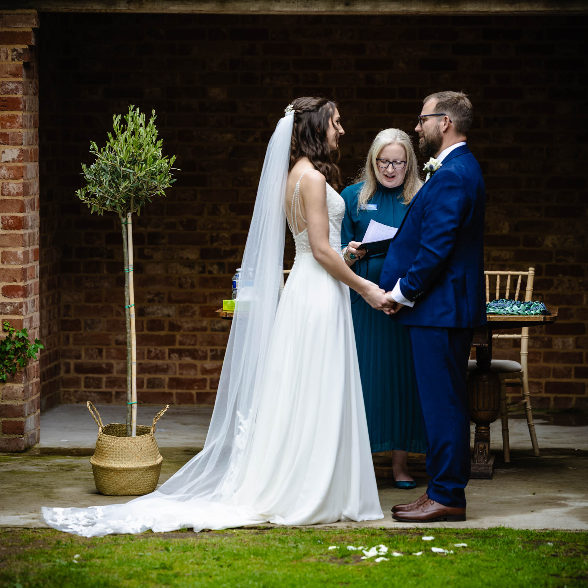 Deb Reed Celebrant Essex Colchester officiating Rachael and Lukes wedding, smiling at their son.